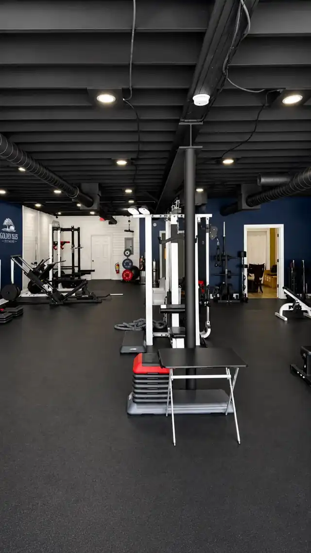 Inside Golden Isles Fitness training floor with power racks, weights and cable machines